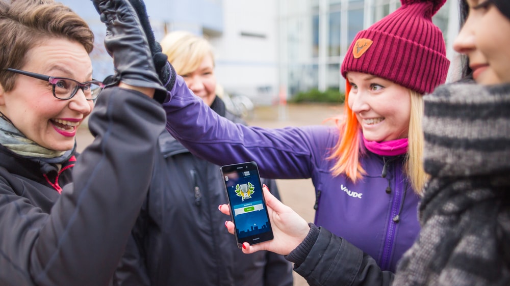 Aikuiset heittävät ylävitosia hymyillen.